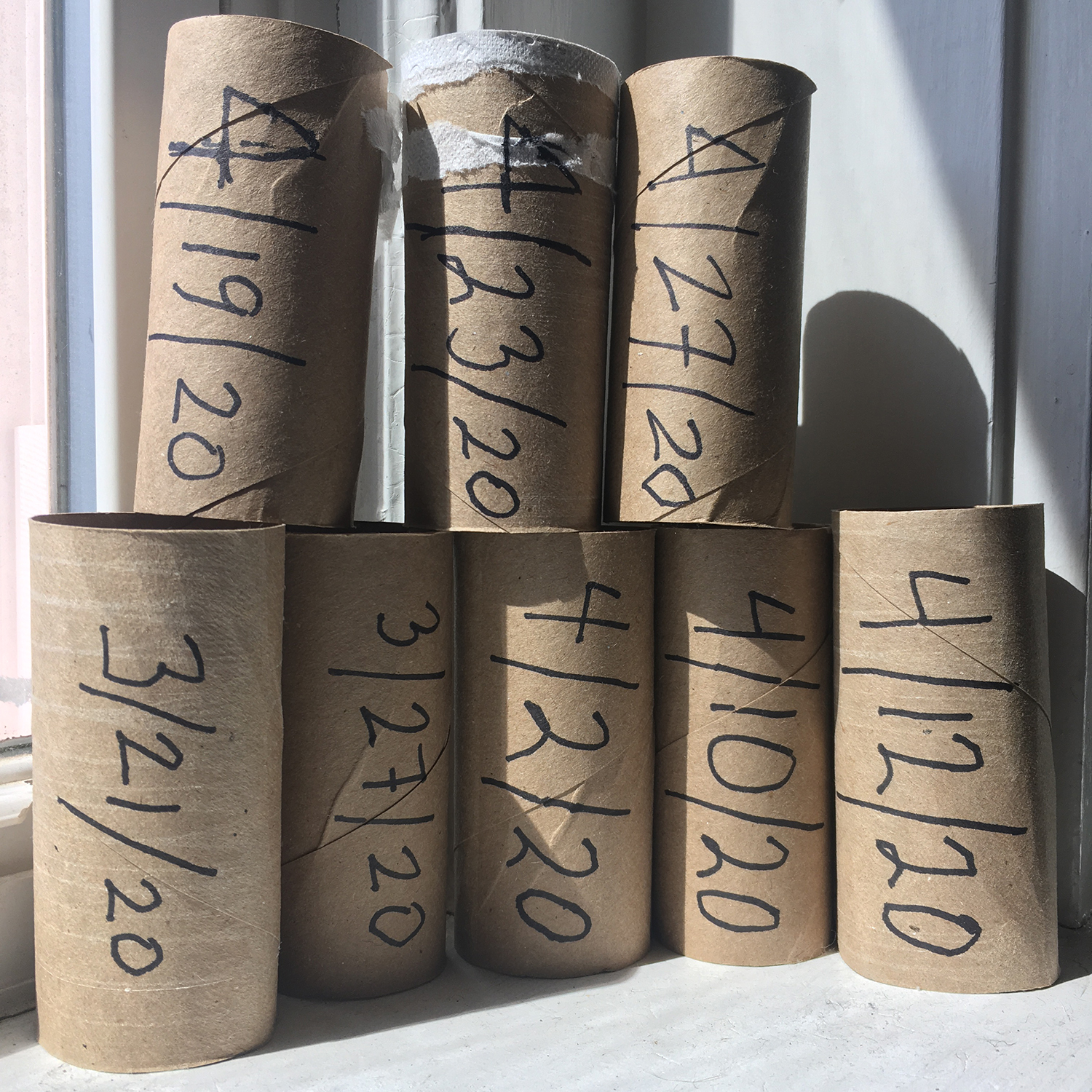 toilet paper rolls time dated with a marker